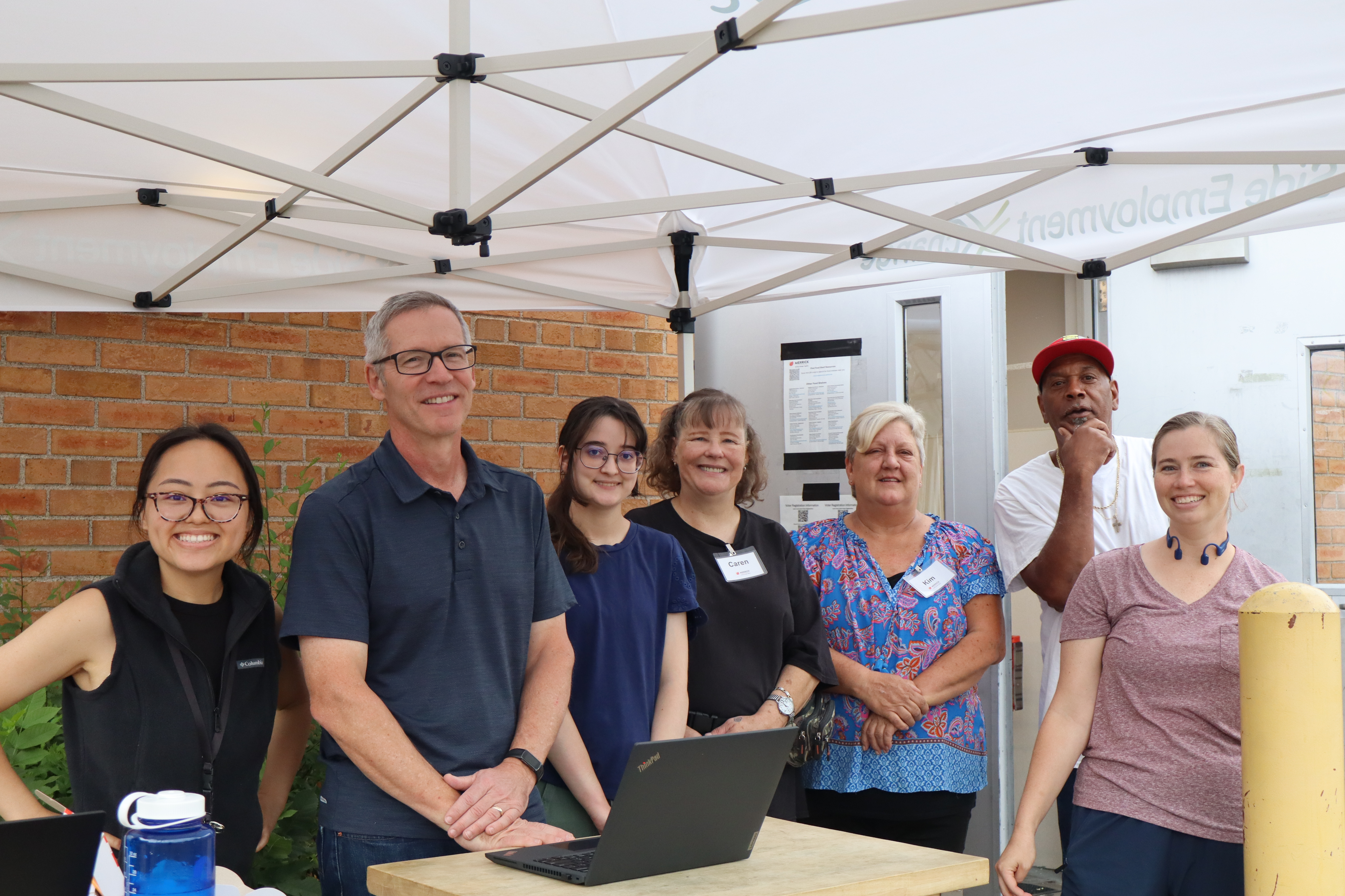 Merrick team gathered at an outdoor community event