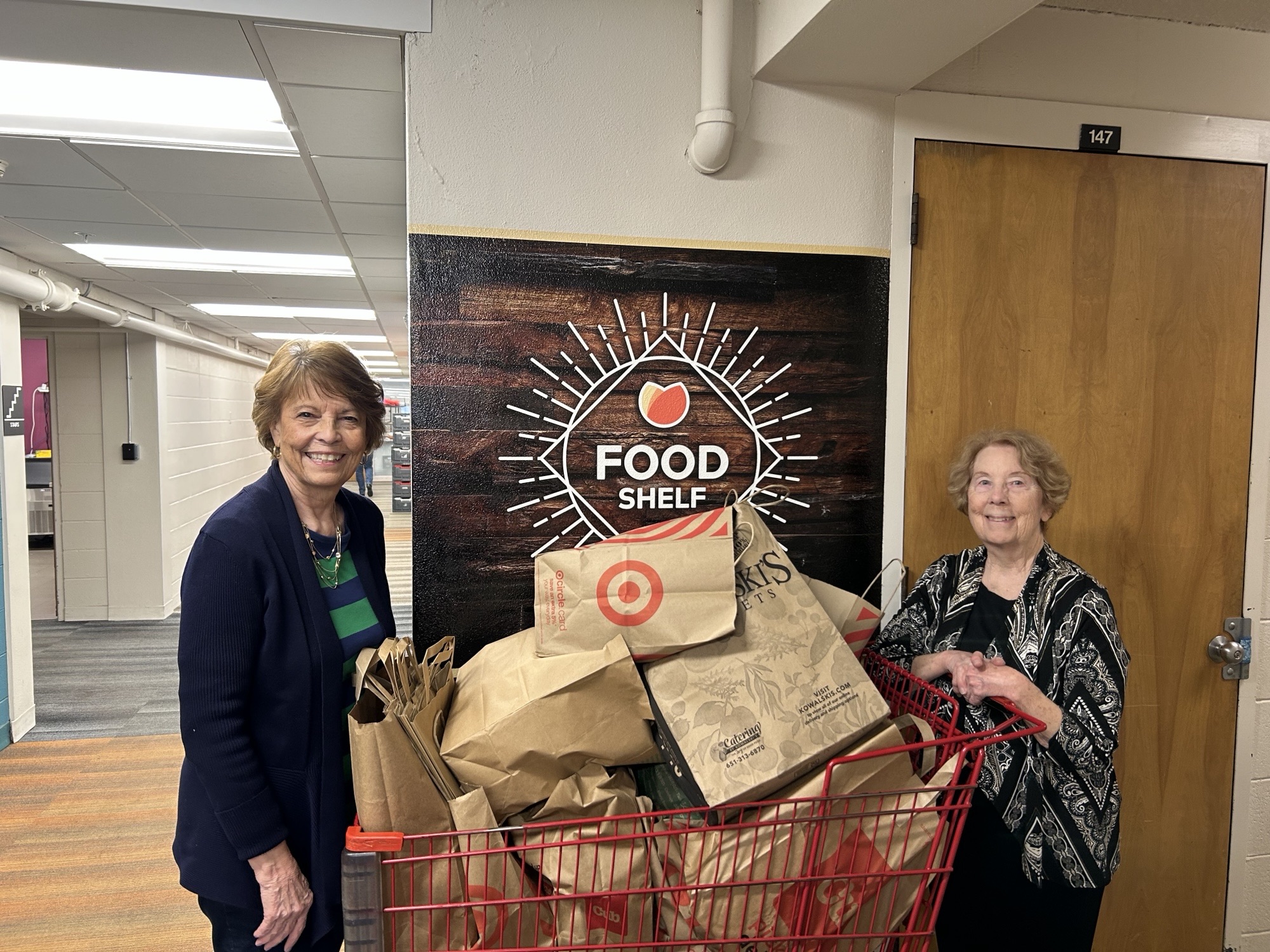 Two people with groceries at Merrick Food Shelf