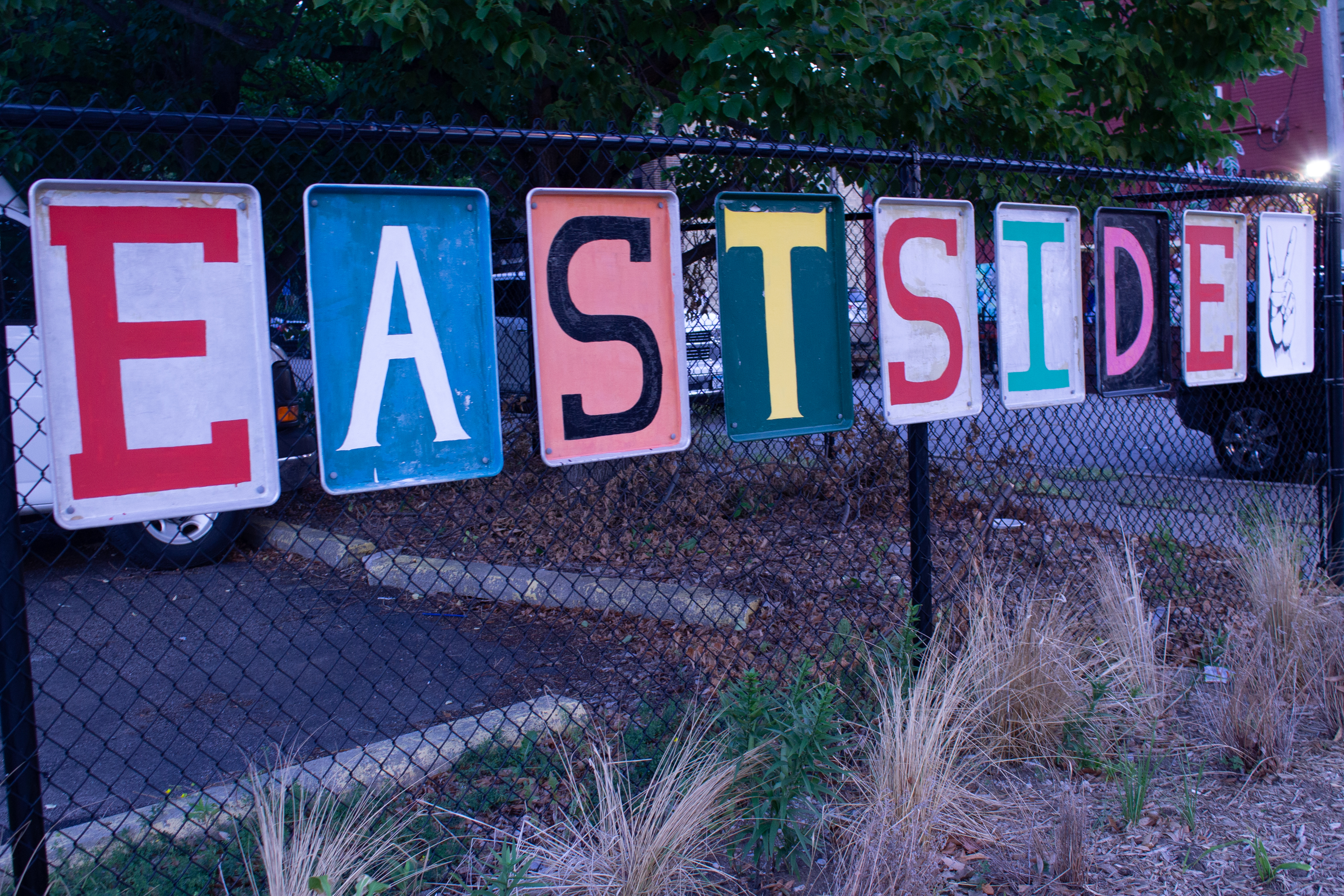 Colorful East Side sign on a neighborhood fence