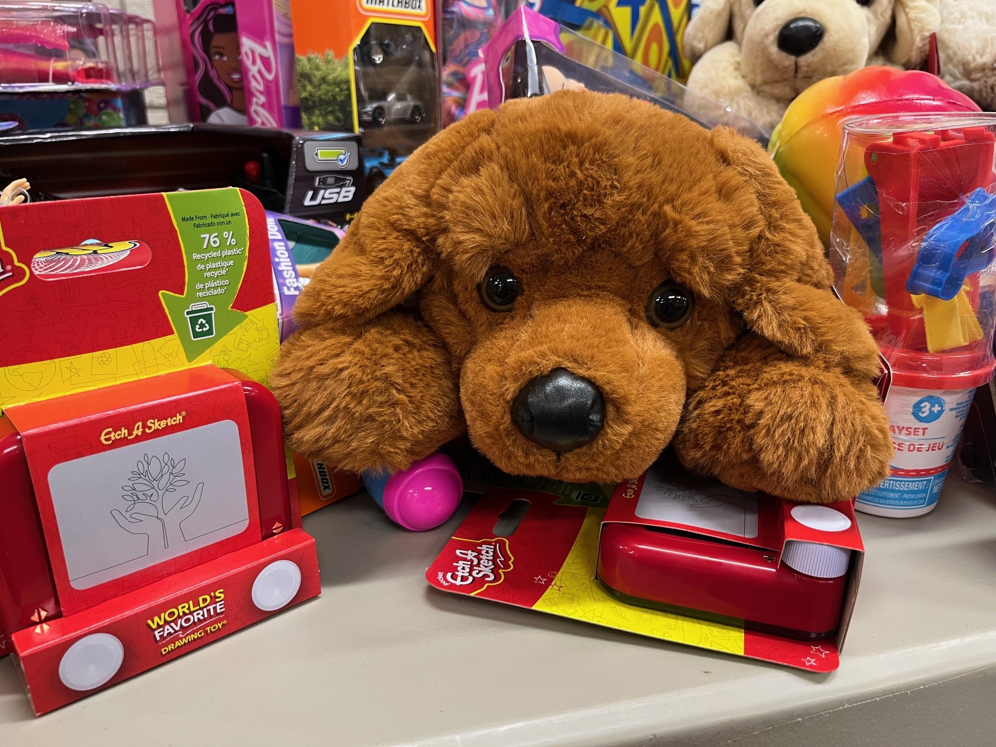A large stuffed dog surrounded by new toys